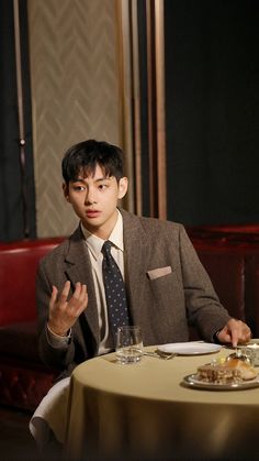 a man sitting at a table in front of a plate