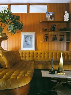 a living room filled with furniture and a potted plant on top of a table