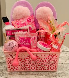 a pink basket filled with personal care items on top of a marble counter next to a mirror