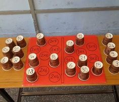 a table topped with lots of cupcakes covered in white frosting and numbers