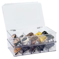 a clear box filled with lots of different types of shoes and sunglasses in it's lid