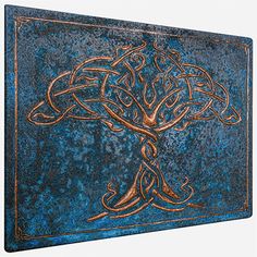 an intricately designed metal plaque with a tree on it's side, against a white background