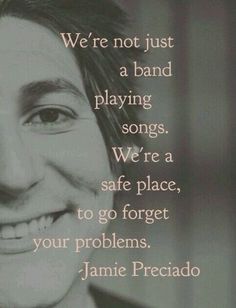 an image of a man smiling with the quote we're not just a band playing songs, we're a safe place to go forget your problems