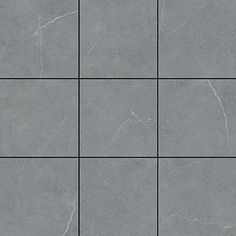 a gray tile wall with squares in it