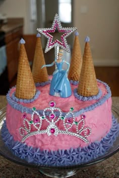 a birthday cake decorated with pink frosting and purple icing, topped with an ice cream cone princess figure