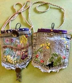 two small purses made out of old jeans with flowers and birds on the back