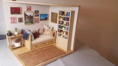 a doll house with furniture and pictures on the wall in it's corner area