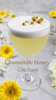 a gin sour cocktail with chamomile honey garnish on the rim