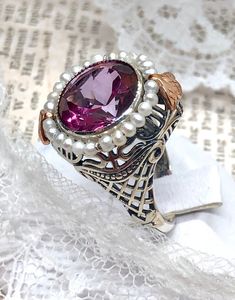 Natural Pink Topaz Ring Round Pearl Design#238 Custom Made This is a stunning Victorian reproduction in sterling silver filigree with a natural 6.5ct pink topaz round bezel stone... The stunning stone is 12 mm...The ring sits 21 mm NS by 17 mm EW... The inside of the band is marked 925 for sterling. Notice the beautiful craftsmanship of the silver filigree setting and band. The small natural pearls are 2 mm wide notice the two rose gold flowers on the top and bottom of the setting... The ring is Vintage Ring With Gemstone Accents As A Gift, Heirloom Topaz Ring With Gemstone Accents As Gift, Victorian Wedding Jewelry With Gemstone Accents, Handmade Elegant Topaz Ring For Anniversary, Elegant Handmade Topaz Ring For Anniversary, Victorian Style Topaz Ring For Gift, Elegant Handmade Topaz Ring For Formal Occasions, Elegant Handmade Topaz Wedding Ring, Victorian Topaz Ring With Accent Stones As Gift