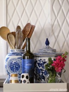 an assortment of kitchen utensils in a blue and white container