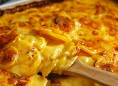 a casserole dish is being served with a wooden spatula