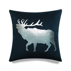 a blue pillow with an image of a moose in the center and antlers on it