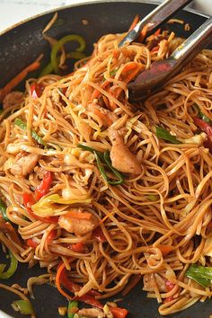 stir fry noodles with chicken and vegetables in a wok