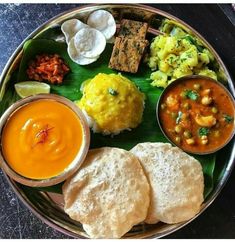 a plate full of different types of food on top of a leafy green surface