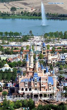 an aerial view of a castle with a fountain in the background