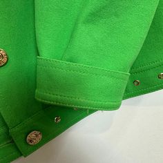 St. John Sport by Marie Gray Green Jacket. Has light shoulder pads. Gold details throughout including logo buttons. Bright green colored lightweight jacket. Collared jacket with button down front. Rivets on the collar and bottom hem. This item have been hemmed at the cuff, however the hem can be let out and returned back to its original cuff length, as shown in photos. Made in the USA Women's size Small Petite Measurements with the garment laying flat: Pit to pit: about 19 inches Length: about 2 Green Spring Outerwear With Buttoned Pockets, Green Outerwear With Buttoned Pockets For Spring, Trendy Green Outerwear With Buttons, Classic Green Outerwear With Buttoned Pockets, Green Buttoned Pockets Outerwear For Work, Green Outerwear With Buttoned Pockets For Work, Green Spring Outerwear With Buttons, Classic Green Outerwear With Button Cuffs, Classic Green Long Sleeve Outerwear