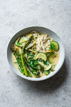 a white bowl filled with noodles and veggies