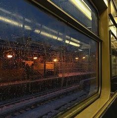 the rain is falling on the window of a train