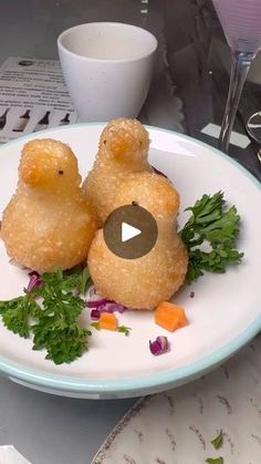 two stuffed animals sitting on top of a white plate