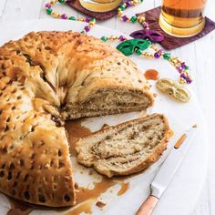 a bundt cake is cut into pieces and sitting on a plate next to a glass of beer