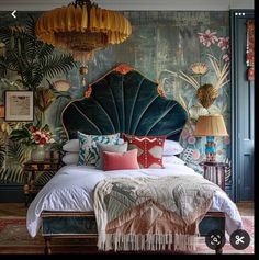 a large bed sitting under a chandelier next to a wall covered in plants