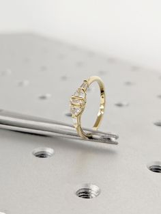 a diamond ring sitting on top of a metal surface