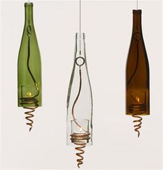 three wine bottles are suspended from the ceiling by wires and cords as if they were blown apart