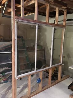 the inside of a house being remodeled with wood framing and glass doors on each side