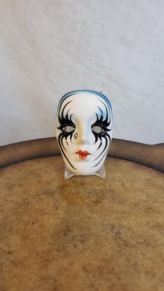 a white mask sitting on top of a wooden table