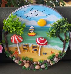 there is a plate that has beach scenes painted on the front and back of it