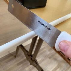 a person holding a large knife on top of a table