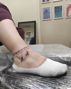 a woman's foot with a tattoo on it