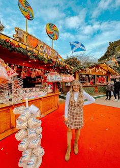 a woman standing in front of an outdoor market