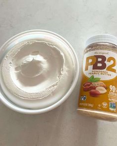 a jar of pb2 powder next to a container of almond butter