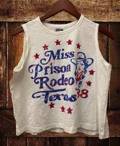 Country Deep Miss Texas Prison Rodeo 1988 Muscle Crop top A feminine version of the muscle crop tank, this womens flowy scoop neck tank top is a must-have style, designed with our exceptionally soft cotton fabrication that softly drapes around curves. The modern armholes and flowy body make it perfect for layering.  Available in Moss color SIZING  Small-body 20 inches wide 18 inches neck to bottom Medium Body-21 inches wide, 19 inches lneck to bottom Large- Body 22 inches wide, 20 inches neck to Texas Prison, Miss Texas, Funky Shirts, Looks Country, 4th Of July Outfits, Scoop Neck Tank Top, Crop Tank Top, Cropped Tube Top, Cropped Tank Top