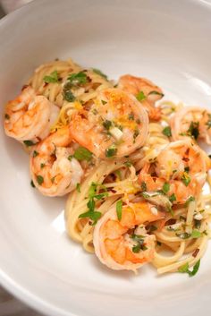 pasta with shrimp and parsley in a white bowl