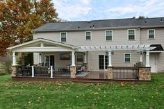 a large house with a covered porch in the front yard and an awning over it