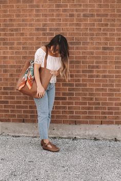 A classic leather tote is a wardrobe staple every girl needs in their life. It’s buttery soft, warm brown leather and minimalistic yet functional design make this a bag that will fit seamlessly into your life. Whether it’s tagging along for a weekend trip to the farmer’s market, holding all your work or school necessities, or traveling with you around the world, you’ll find this beautiful genuine leather tote the bag you reach for over and over again. PRODUCT DETAILS Made with 100% high-quality Classic Leather Tote, Handmade Leather Boots, Functional Clothing, Genuine Leather Totes, The Farmer, Mama Style, Classic Brown, Girl Needs, Weekend Trip