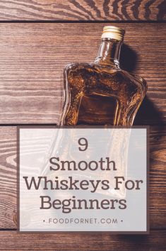 a bottle of whiskey sitting on top of a wooden table with the words 9 smooth whiskers for beginners