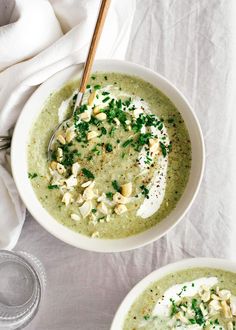 two bowls filled with soup on top of a table