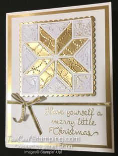 a white and gold christmas card with an ornament