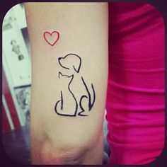 a woman's arm with a dog and heart tattoo on the left side of her arm