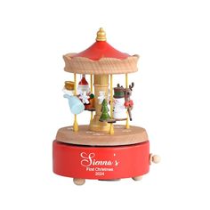 a toy carousel with christmas decorations on it's top and the words santa written in red