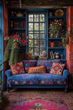 a blue couch sitting in front of a window