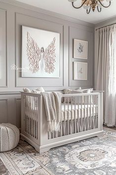 a baby's room with a crib, rug and pictures on the wall