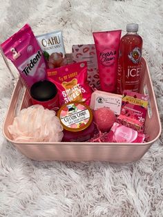 a pink basket filled with lots of different types of cosmetics and personal care products on a white carpet