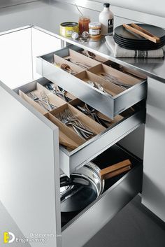 an open drawer in the middle of a kitchen