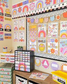 a classroom with lots of colorful bulletin boards on the wall and drawers in front of it