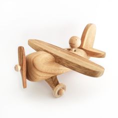 a wooden toy airplane on a white background