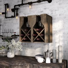 a wooden table topped with vases filled with flowers and bottles next to a brick wall